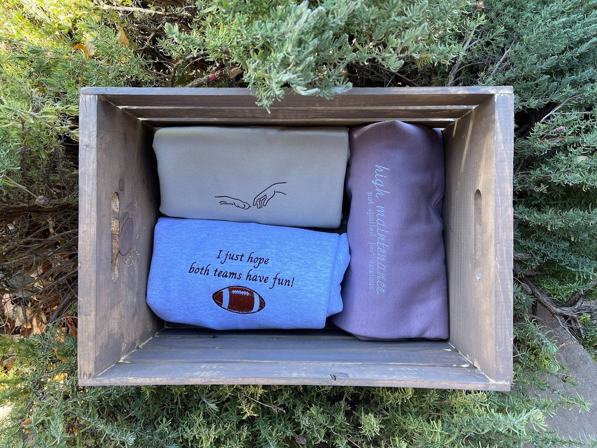 Collection of 3 various sweatshirts from the seller in a wooden box